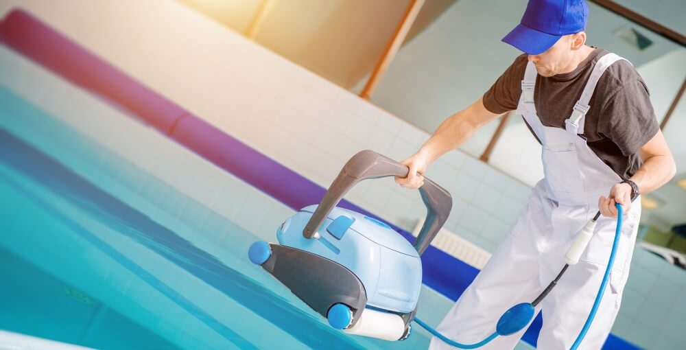 Pool technician with a robotic pool cleaner